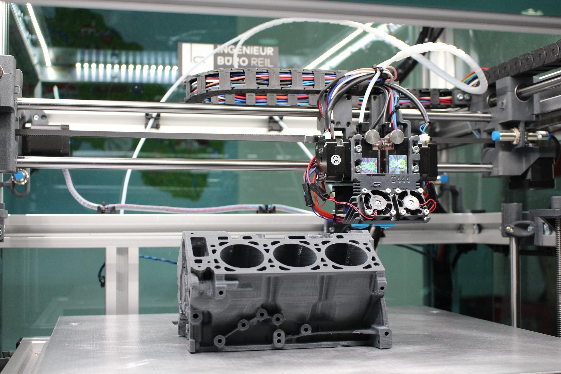 Image of a 3d printer and engine block